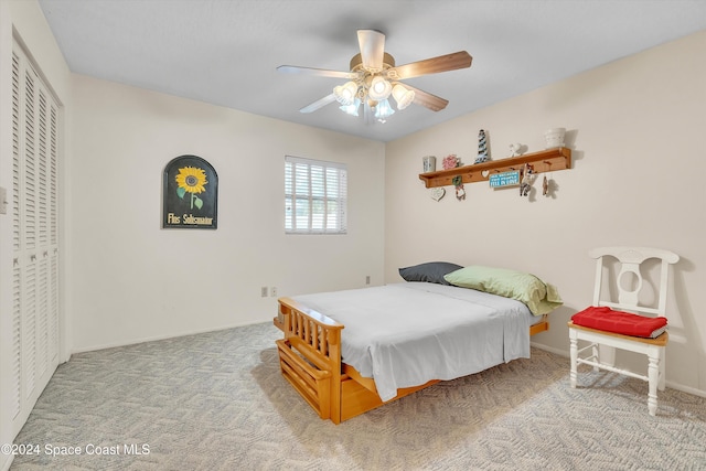 bedroom featuring carpet, ceiling fan, and a closet