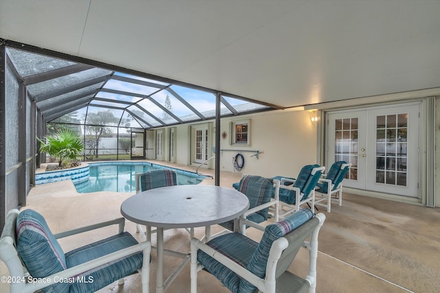 view of swimming pool featuring a patio area, a lanai, and french doors