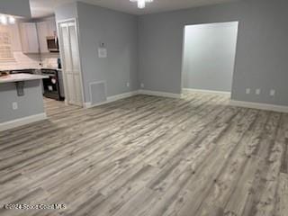 unfurnished living room with light hardwood / wood-style floors and ceiling fan