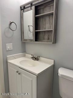 bathroom featuring vanity and toilet