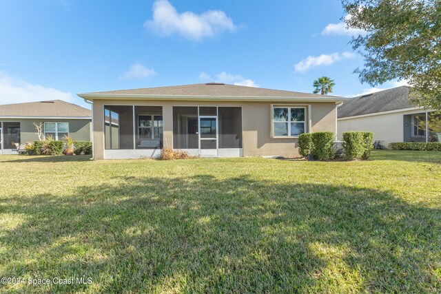 2342 Planter Ridge Ct, Palm Bay, FL 32909 - back of property featuring a sunroom, a yard, and stucco siding