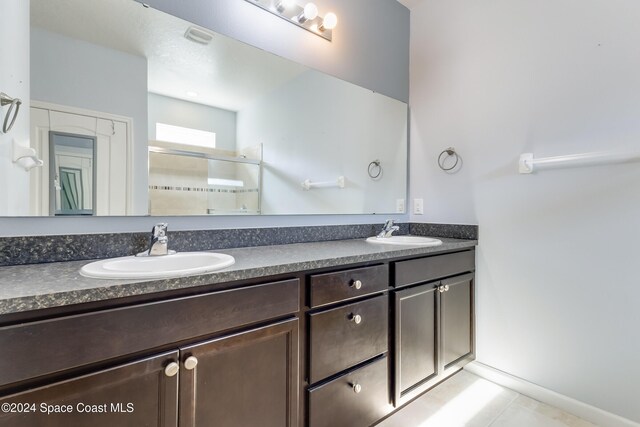 2342 Planter Ridge Ct, Palm Bay, FL 32909 - full bath with double vanity, a shower stall, and tile patterned flooring