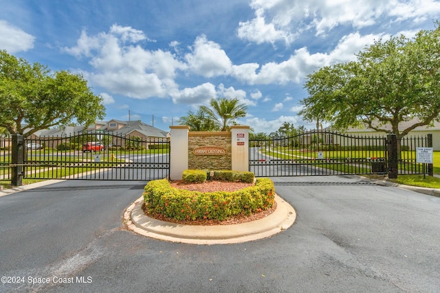 2342 Planter Ridge Ct, Palm Bay, FL 32909 - view of asphalt street featuring a gate, a gated entry, and curbs