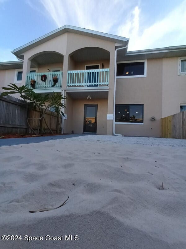 view of front of house featuring a balcony