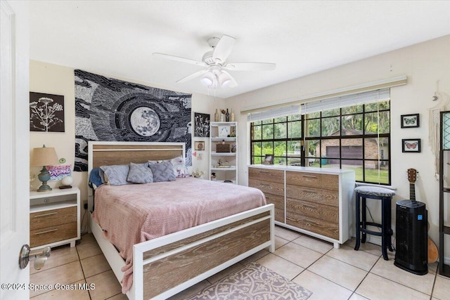 tiled bedroom featuring ceiling fan