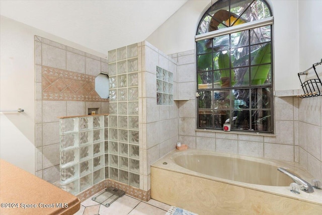 bathroom with tile patterned floors and plus walk in shower