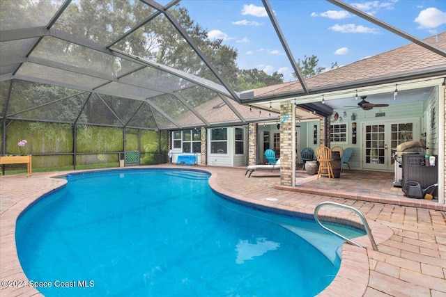 view of swimming pool featuring a patio, ceiling fan, and a lanai