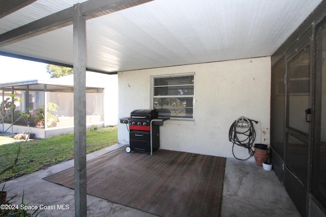 view of patio with a grill and a sunroom