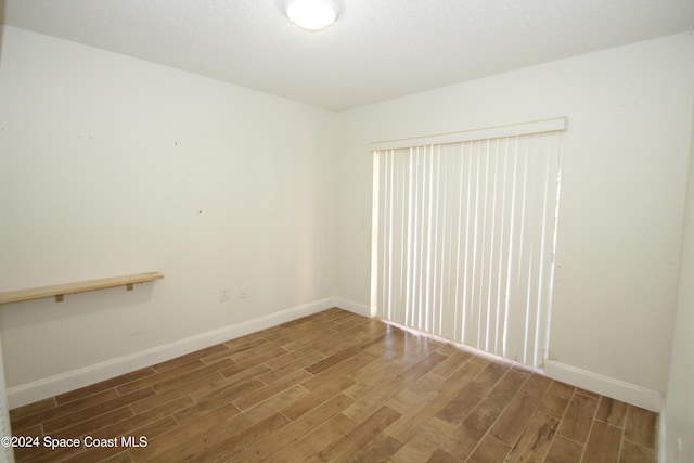 unfurnished room with hardwood / wood-style floors