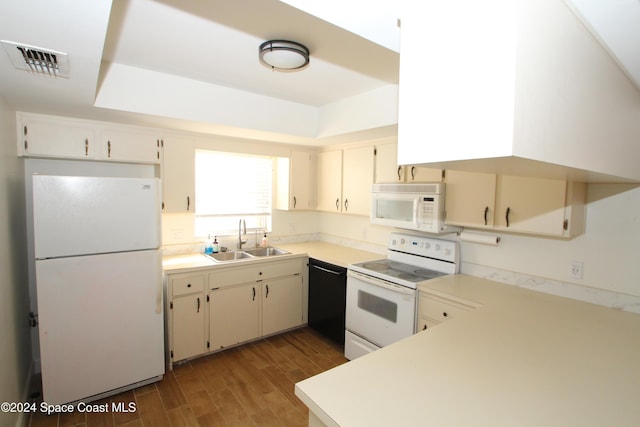 kitchen with hardwood / wood-style floors, white appliances, and sink