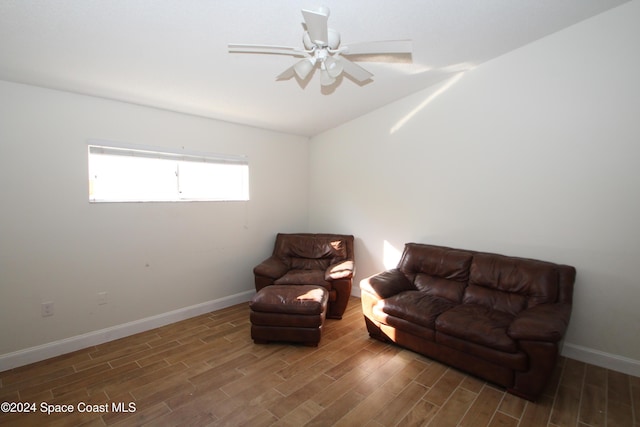 living area with ceiling fan and dark wood-type flooring