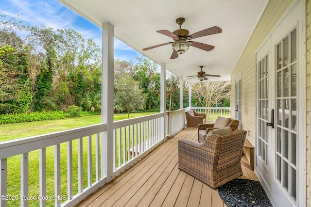 deck with ceiling fan and a lawn