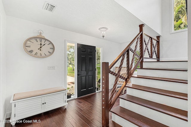 entryway featuring dark hardwood / wood-style flooring and a textured ceiling