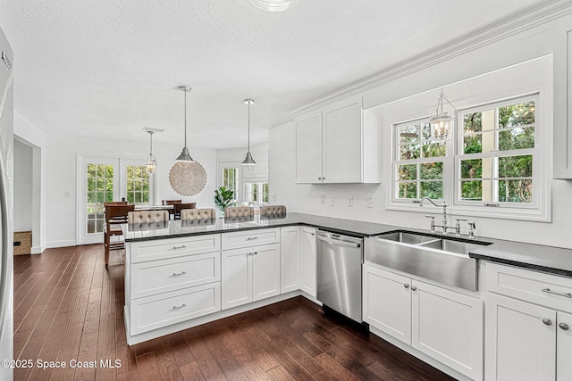 kitchen with dishwasher, white cabinets, sink, hanging light fixtures, and kitchen peninsula