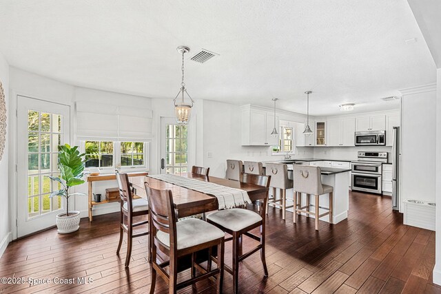 dining space featuring dark hardwood / wood-style flooring