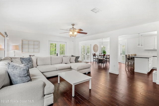 living room featuring ceiling fan, french doors, and dark hardwood / wood-style floors