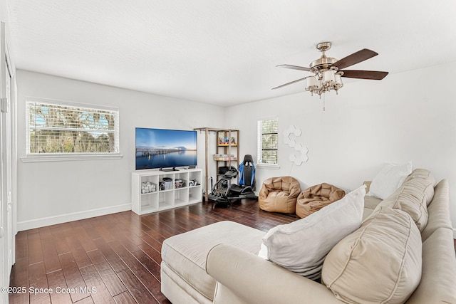 living room with ceiling fan, a healthy amount of sunlight, and dark hardwood / wood-style floors