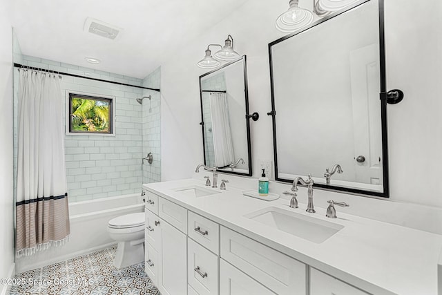 full bathroom with tile patterned floors, vanity, shower / bath combo, and toilet