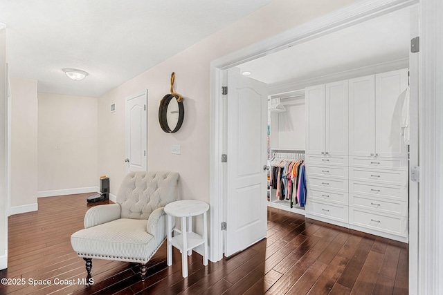 sitting room featuring dark wood-type flooring