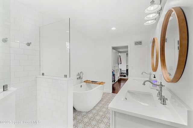 bathroom featuring tile patterned flooring, vanity, and independent shower and bath