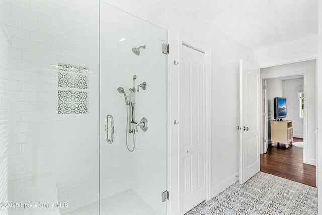 bathroom with tile patterned floors and an enclosed shower