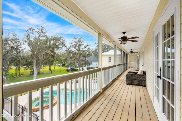 wooden terrace with ceiling fan and a water view