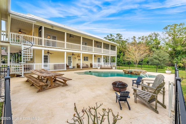 view of swimming pool featuring an in ground hot tub, a patio, and an outdoor fire pit