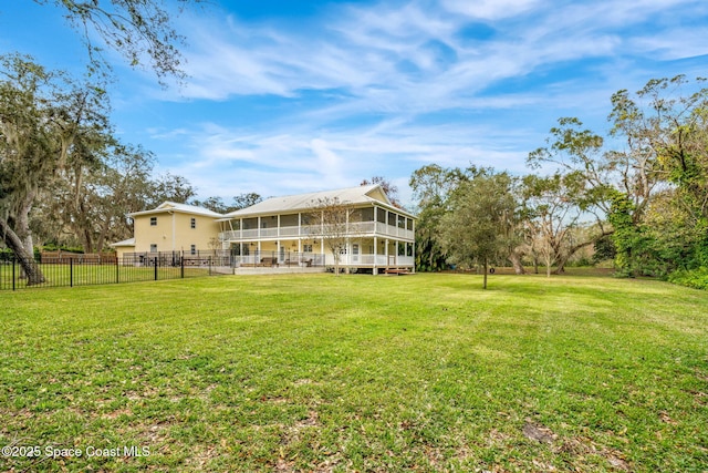 back of house with a sunroom and a yard