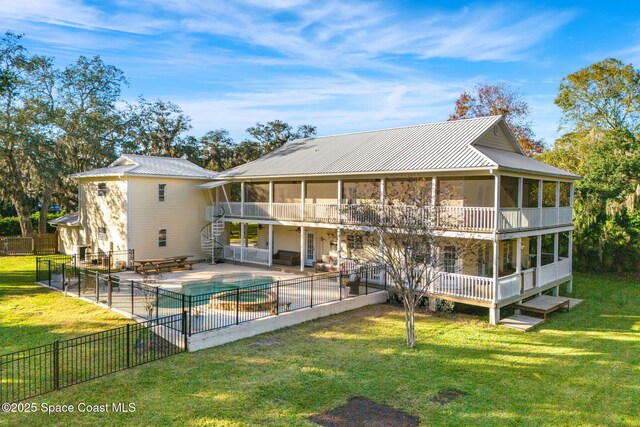 rear view of property featuring a yard, a patio, a fenced in pool, and an outdoor living space