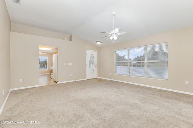 carpeted empty room featuring ceiling fan and lofted ceiling