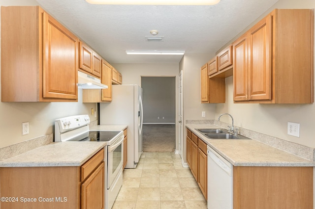 kitchen with a textured ceiling, white appliances, and sink