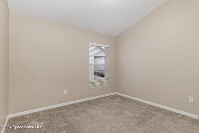 1796 Alaqua Way, Melbourne, FL 32904 - spare room with carpet flooring and vaulted ceiling