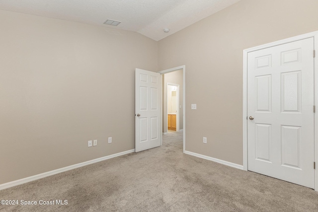 1796 Alaqua Way, Melbourne, FL 32904 - unfurnished bedroom with lofted ceiling and light carpet