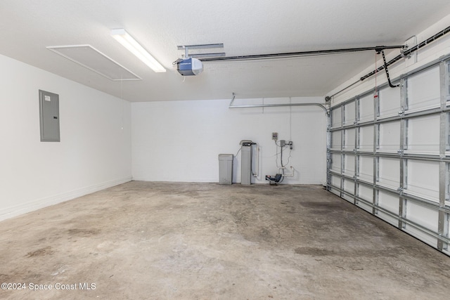 garage with a garage door opener and electric panel