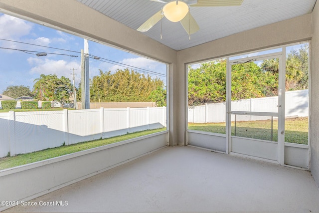 unfurnished sunroom featuring a wealth of natural light and ceiling fan