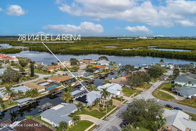 drone / aerial view featuring a residential view and a water view