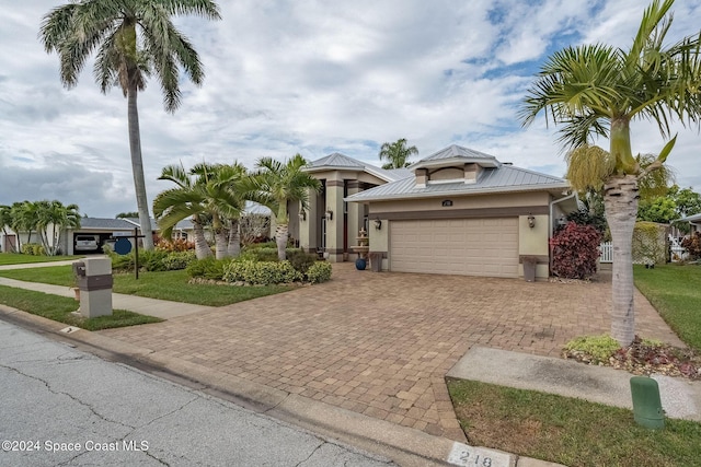 view of front of house with a garage and a front yard