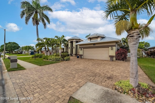 view of front facade with a garage and a front lawn