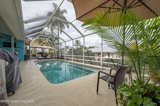 view of pool featuring a lanai and a patio