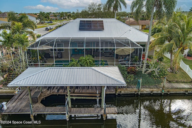 view of dock featuring a water view and glass enclosure