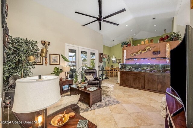 interior space with french doors, ceiling fan, and high vaulted ceiling