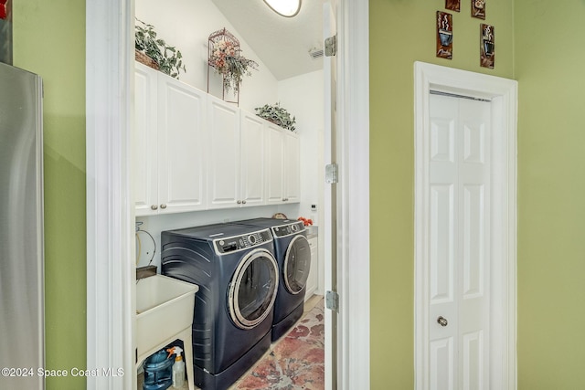 laundry room with cabinets and separate washer and dryer