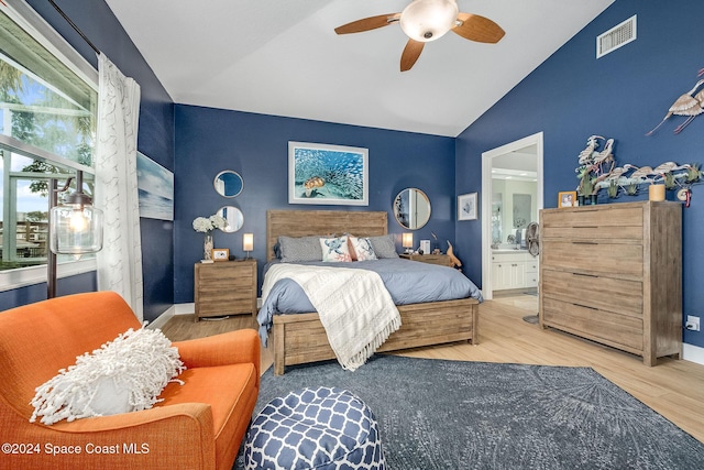 bedroom featuring ceiling fan, lofted ceiling, connected bathroom, and wood-type flooring