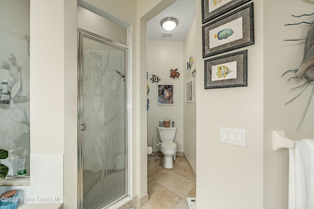 bathroom with a shower with door, tile patterned flooring, and toilet