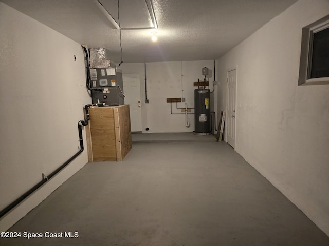 basement with heating unit, a textured ceiling, and water heater