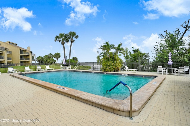 view of swimming pool with a patio