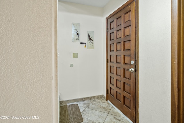 foyer featuring light tile patterned floors