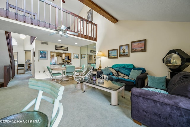 carpeted living room with beam ceiling, ceiling fan, and high vaulted ceiling