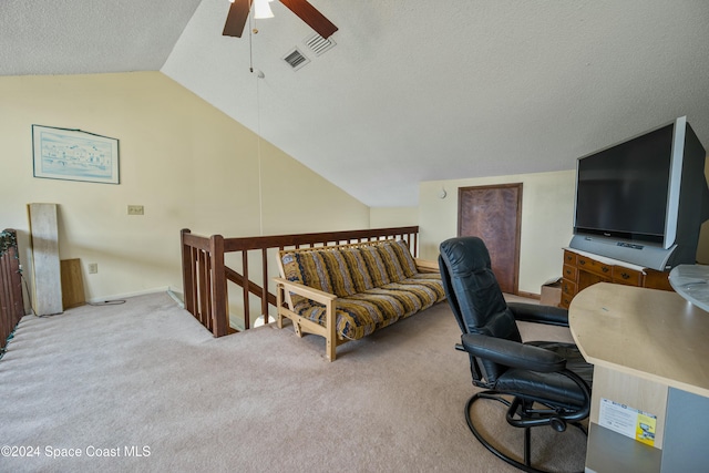 office featuring a textured ceiling, ceiling fan, lofted ceiling, and light carpet