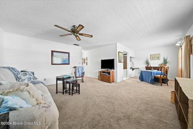 carpeted living room with a textured ceiling and ceiling fan